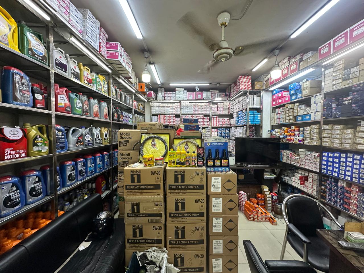Aisle of genuine engine oils, lubricants and KYB parts inside Jaman Autos
